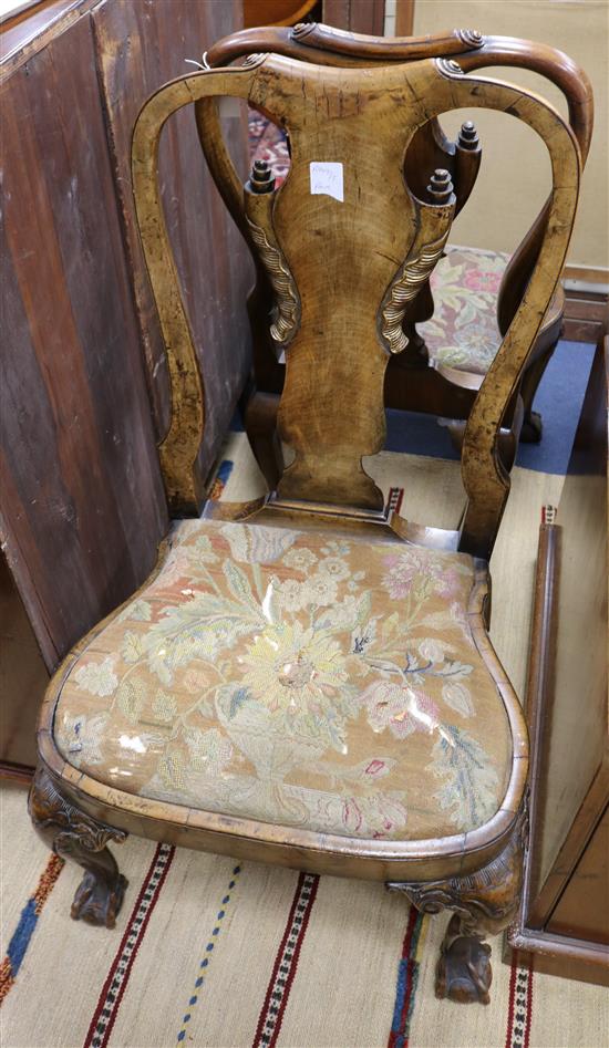 A pair of George I style walnut and parcel-gilt dining chairs